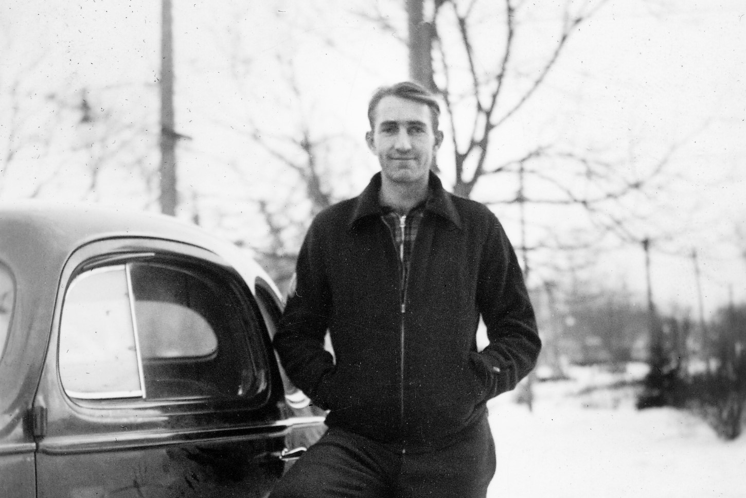 Dave Packard posing beside a car in 1936.