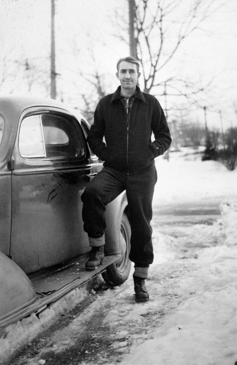 Dave Packard posing beside a car in 1936.