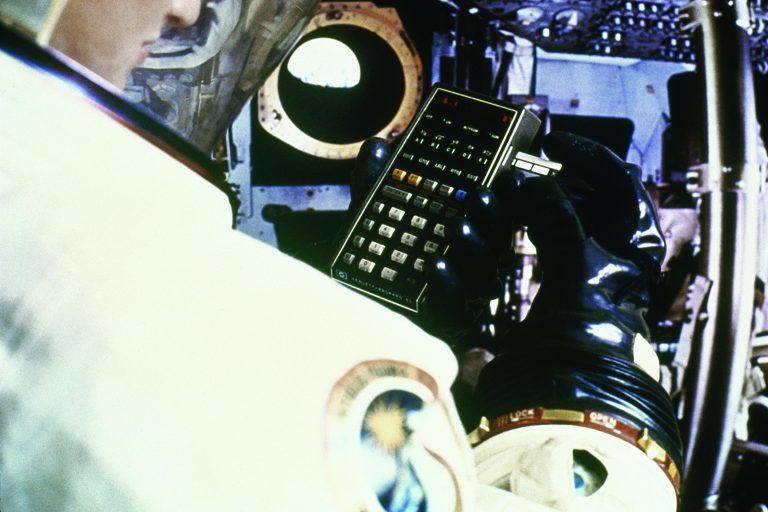 HP 41C calculator being used by a person in a spacesuit. 