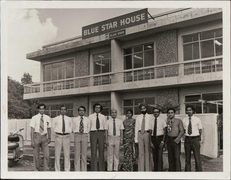 Photo of unnamed Blue Star team members in front of the Blue Star House building.