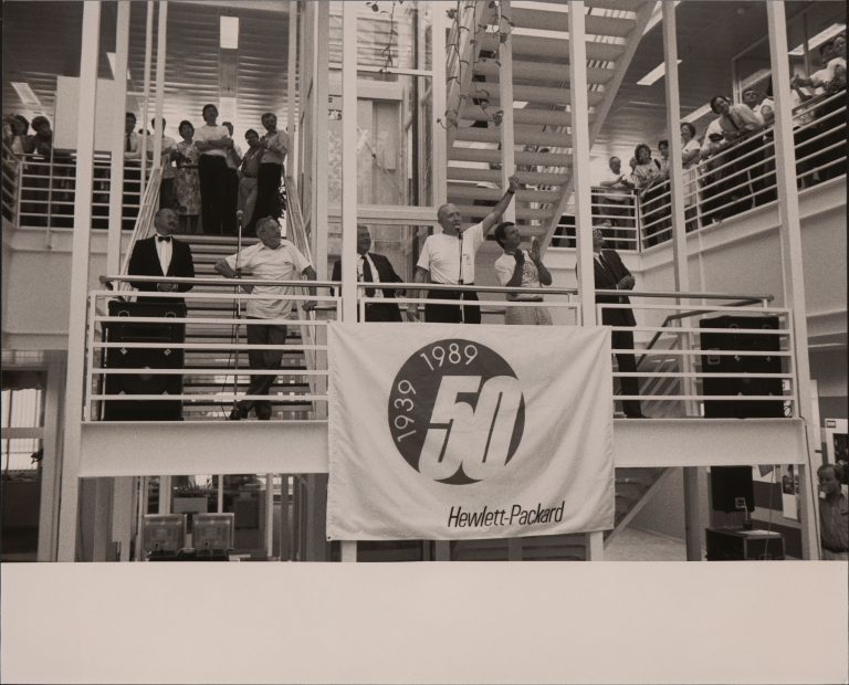 A crowd gathers in a stairwell during the 50th anniversary celebration at Hewlett-Packard S.A.