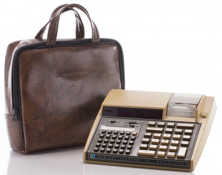 The HP 97 personal calculator with in-unit printer. Photographed with leather carrying bag.