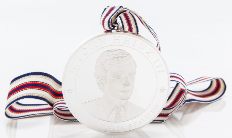 Back of the Heinz Chairman's Medal featuring H. John Heinz III's photo, name and the phrase Shared Ideals Realized.
