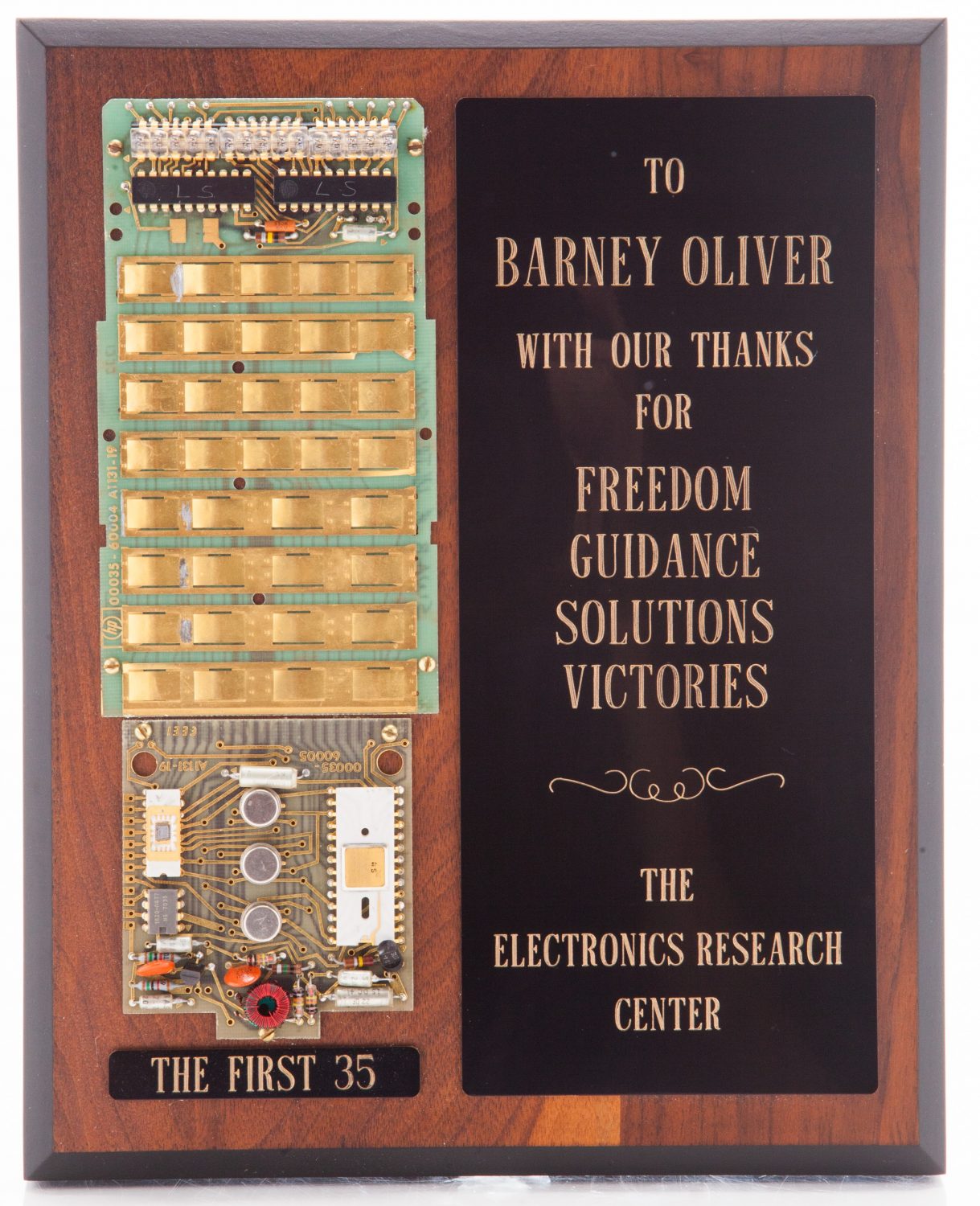 Plaque given to Barney Oliver with mounted components of the first HP 35 logic chip and keyboard infrastructure.