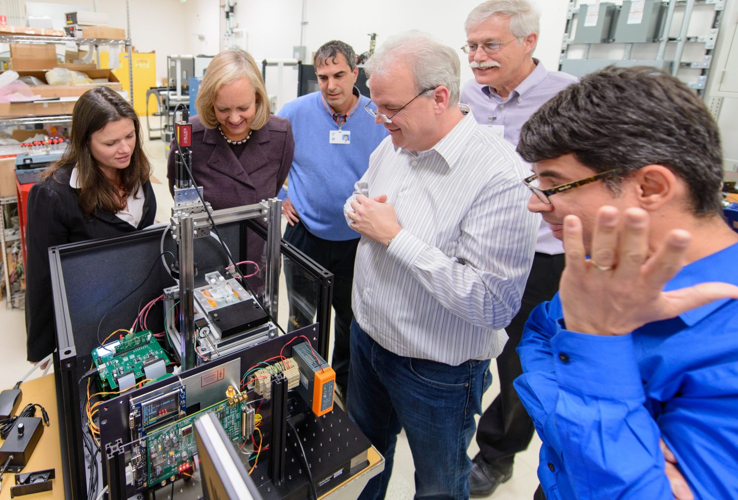 HP CEO Meg Whitman checks out a prototype of a gift card writing machine during a tour in 2014.