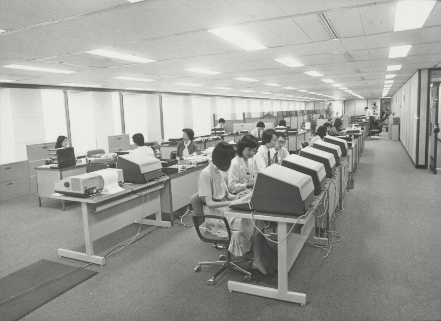 Photo of employees working at terminals in Hewlett-Packard's Hong Kong office in 1981.