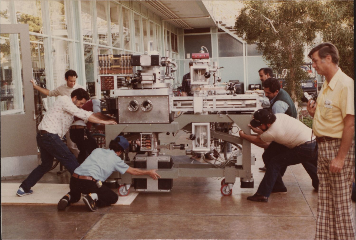 Men moving Hewlett-Packard's e-beam system in 1984.