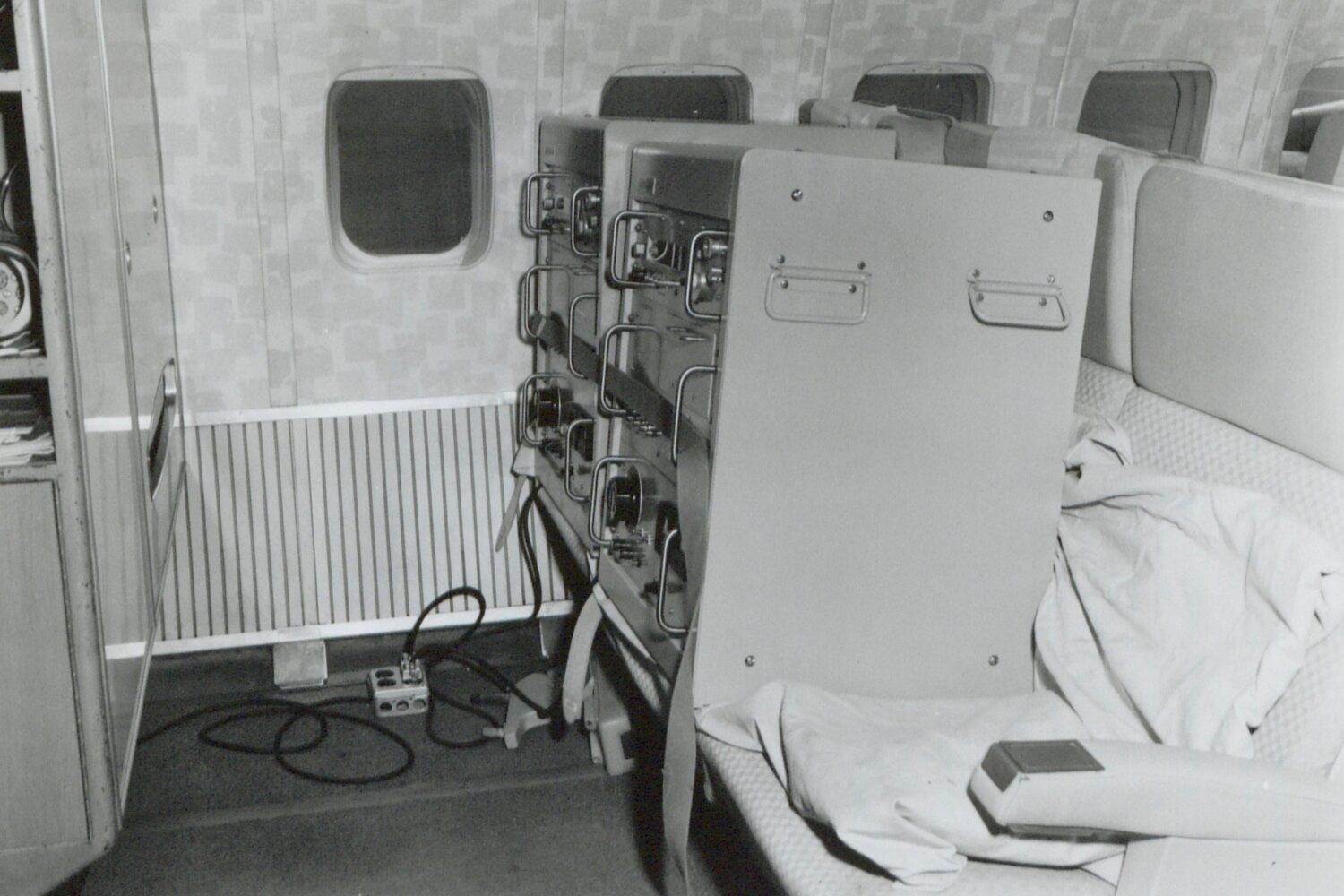 Photo of two HP 5060As in commercial airplane seats during their global tour.