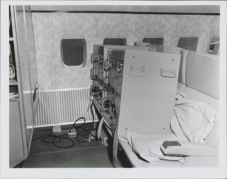 Photo of two HP 5060As in commercial airplane seats during their global tour.