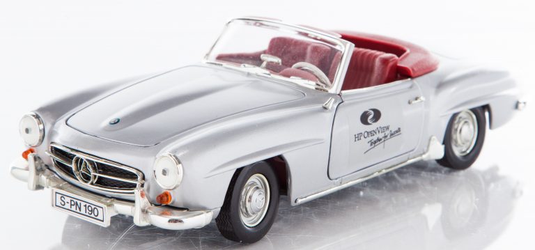 A model of a Mercedes-Benz 190SL with top down featuring the HP OpenView logo on the door.