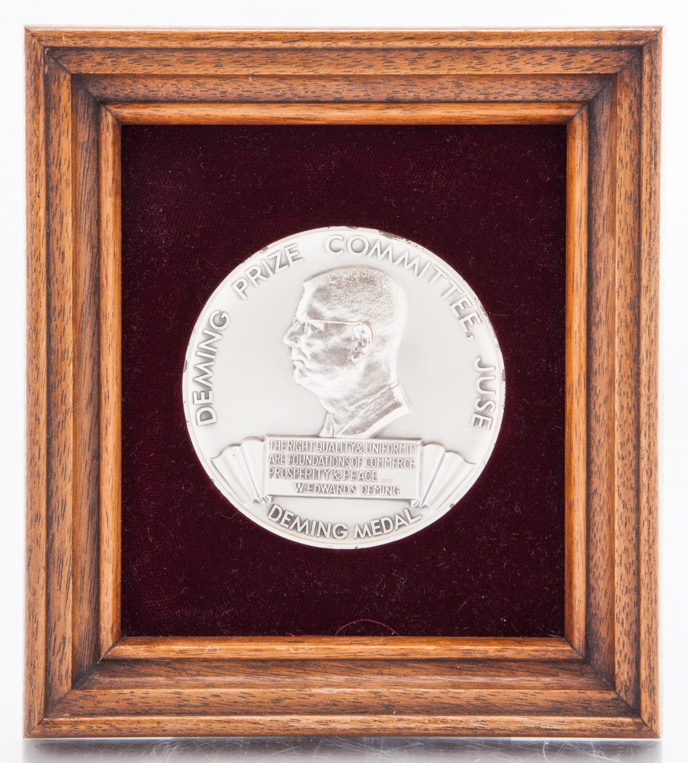 Front view of the Deming Prize featuring a profile view of W. Edwards Deming.