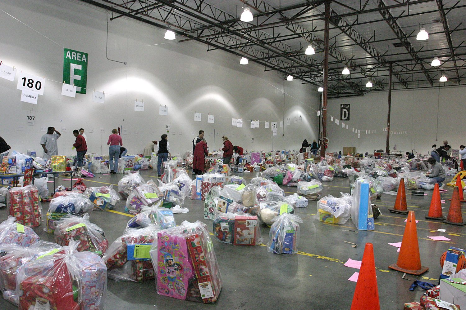 Hewlett-Packard employees work to bundle bags of toys as part of the Family Giving Tree program in 2016.