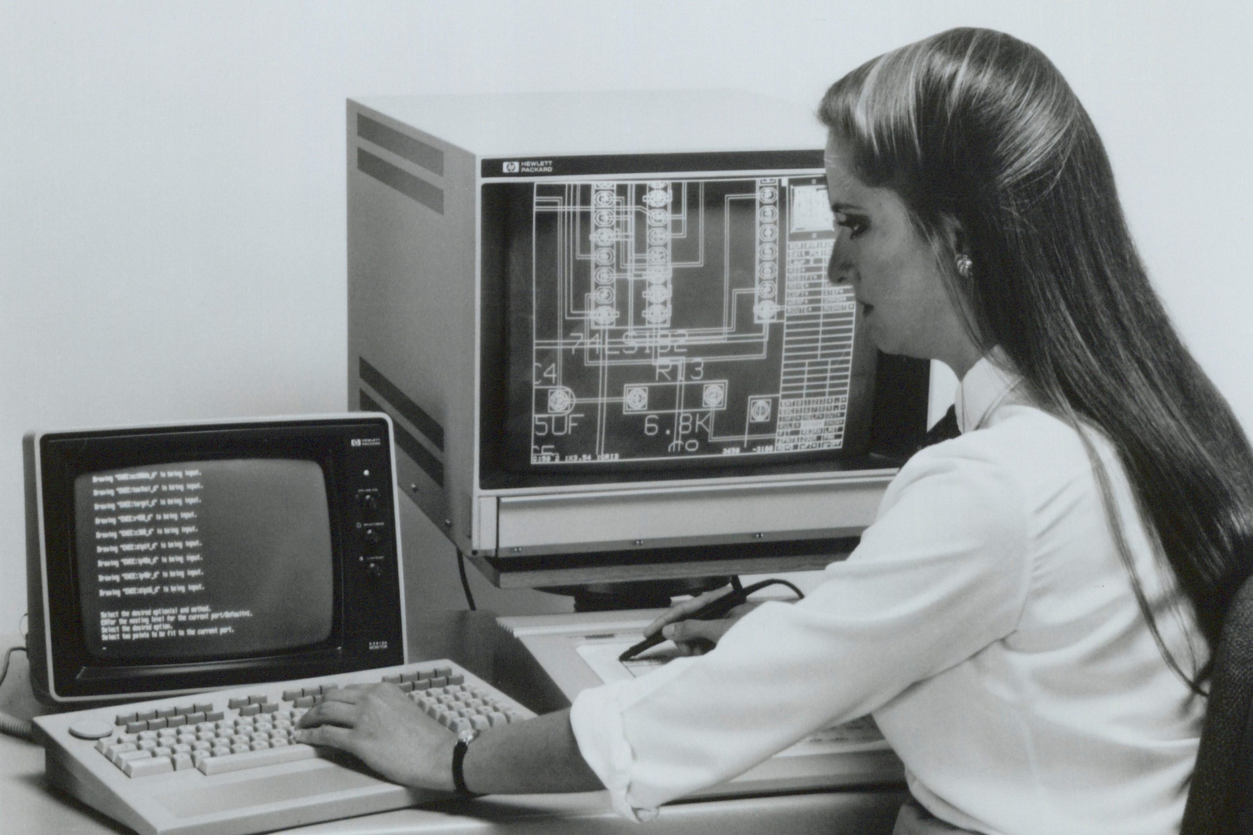 Woman working with HP's Engineering Graphics System software on an HP 9000 Series 200 engineering workstation computer.