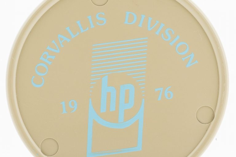 A coaster celebrating the opening of Hewlett-Packard's Corvallis facility in 1976.