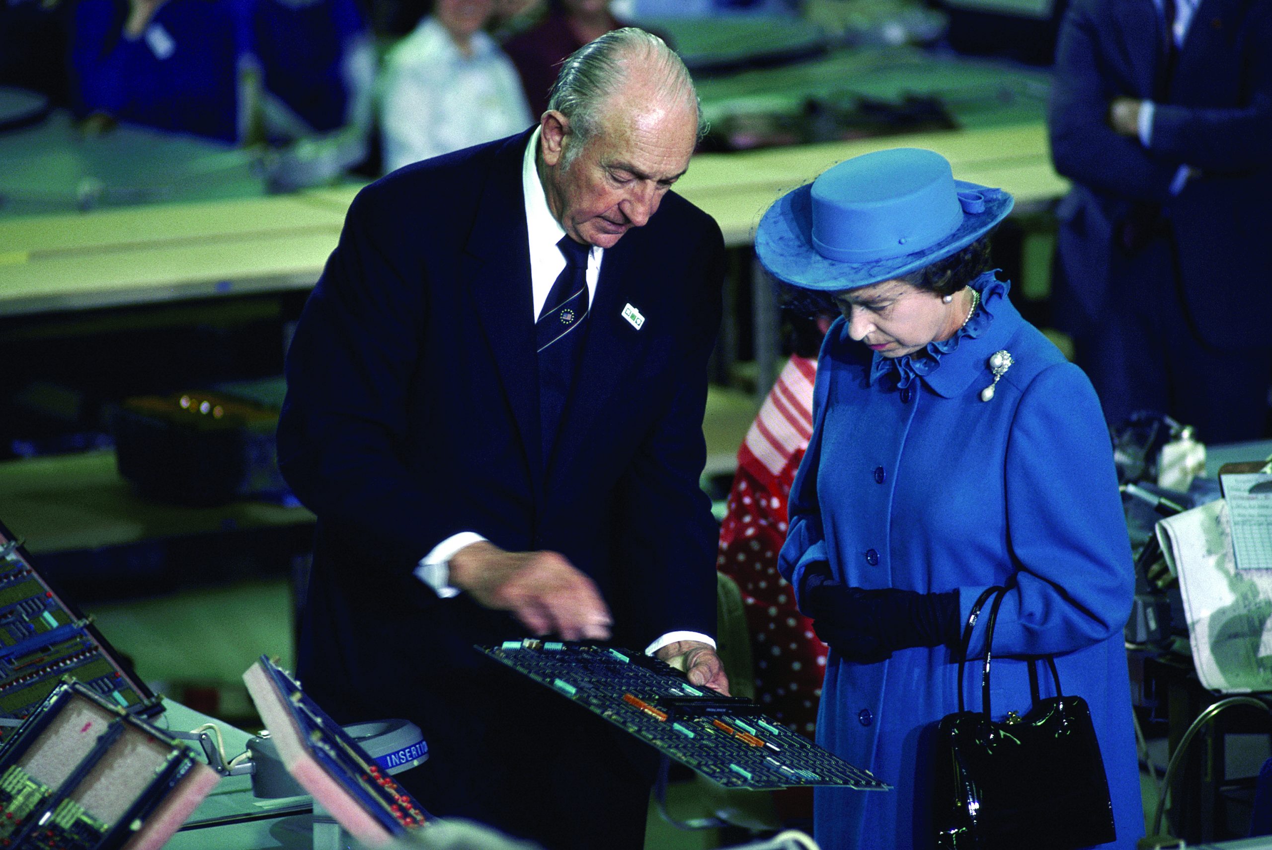 Photo of Dave Packard showing a circuit board to Queen Elizabeth II during her visit to HP Cupertino.