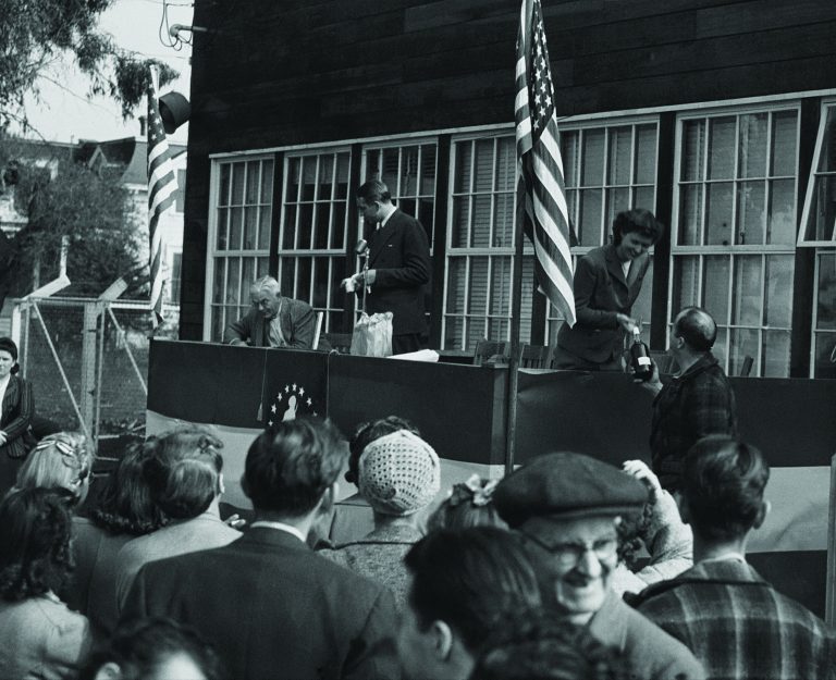 Dave and Lucile Packard announcing raffle winners in 1945.