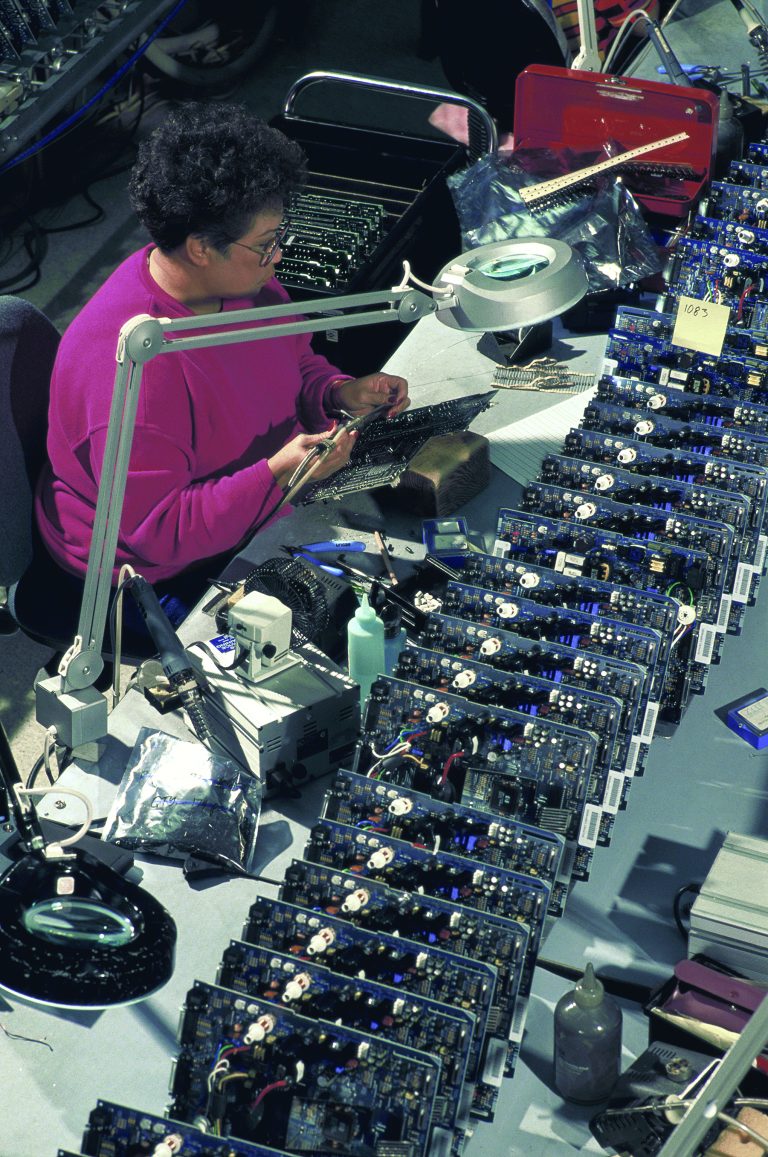 A woman works on a circuit board at the Roseville manufacturing facility in 1993.