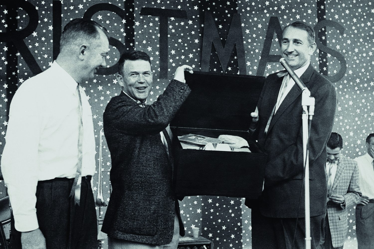 Bill Hewlett and Dave Packard presenting a box of gifts during a Hewlett-Packard holiday party in 1947.