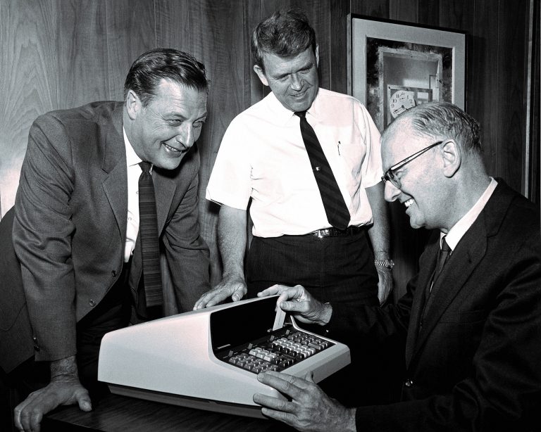 Barney Oliver and Bill Hewlett showing science fiction author Arthur C. Clarke a prototype of the HP 9100A. 