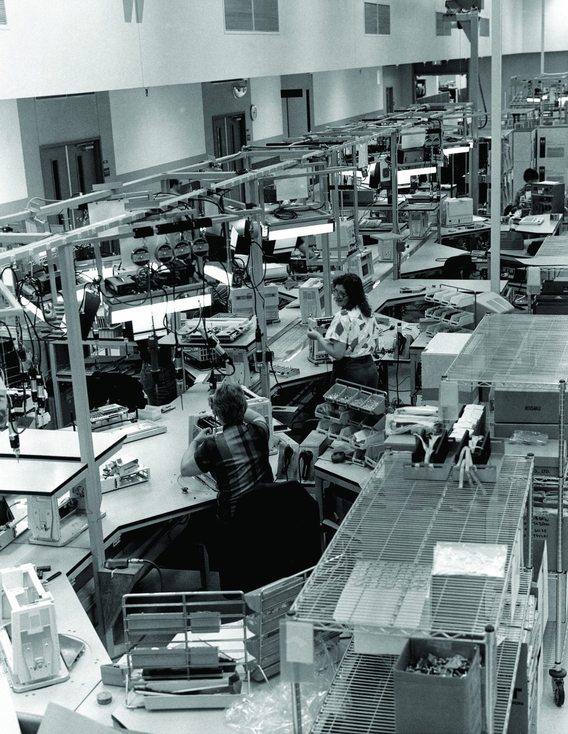 Two women working on the production line assembling Hewlett-Packard Integral luggable PCs in 1985.