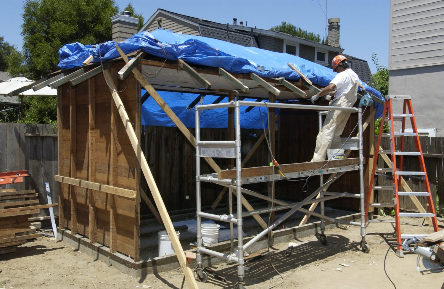 A worker working on the roof of Bill Hewlett's shed on Addison Avenue.