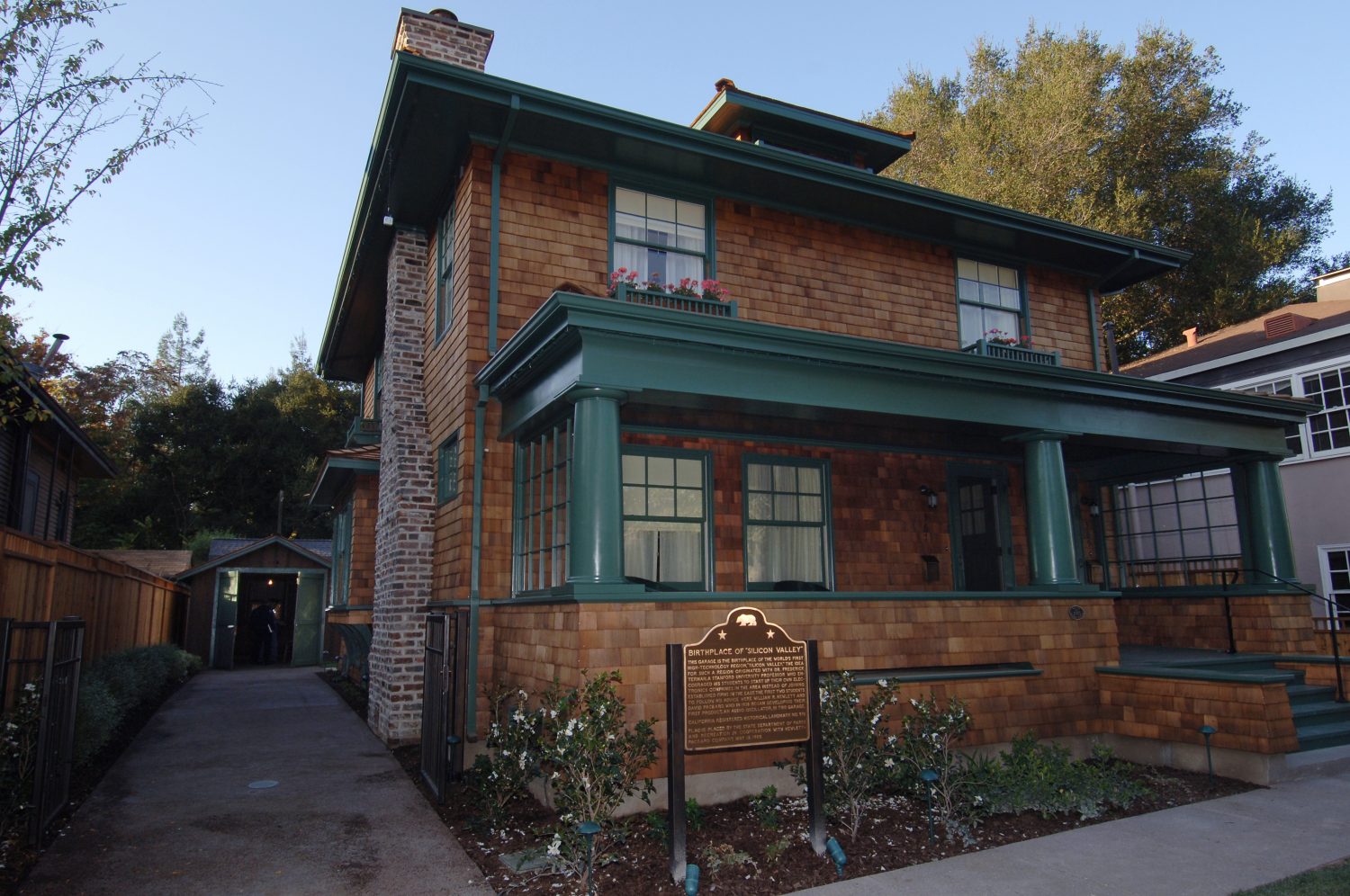 Photo of the restored Hewlett-Packard house with a plaque indicating its listing in the National Historic Register.