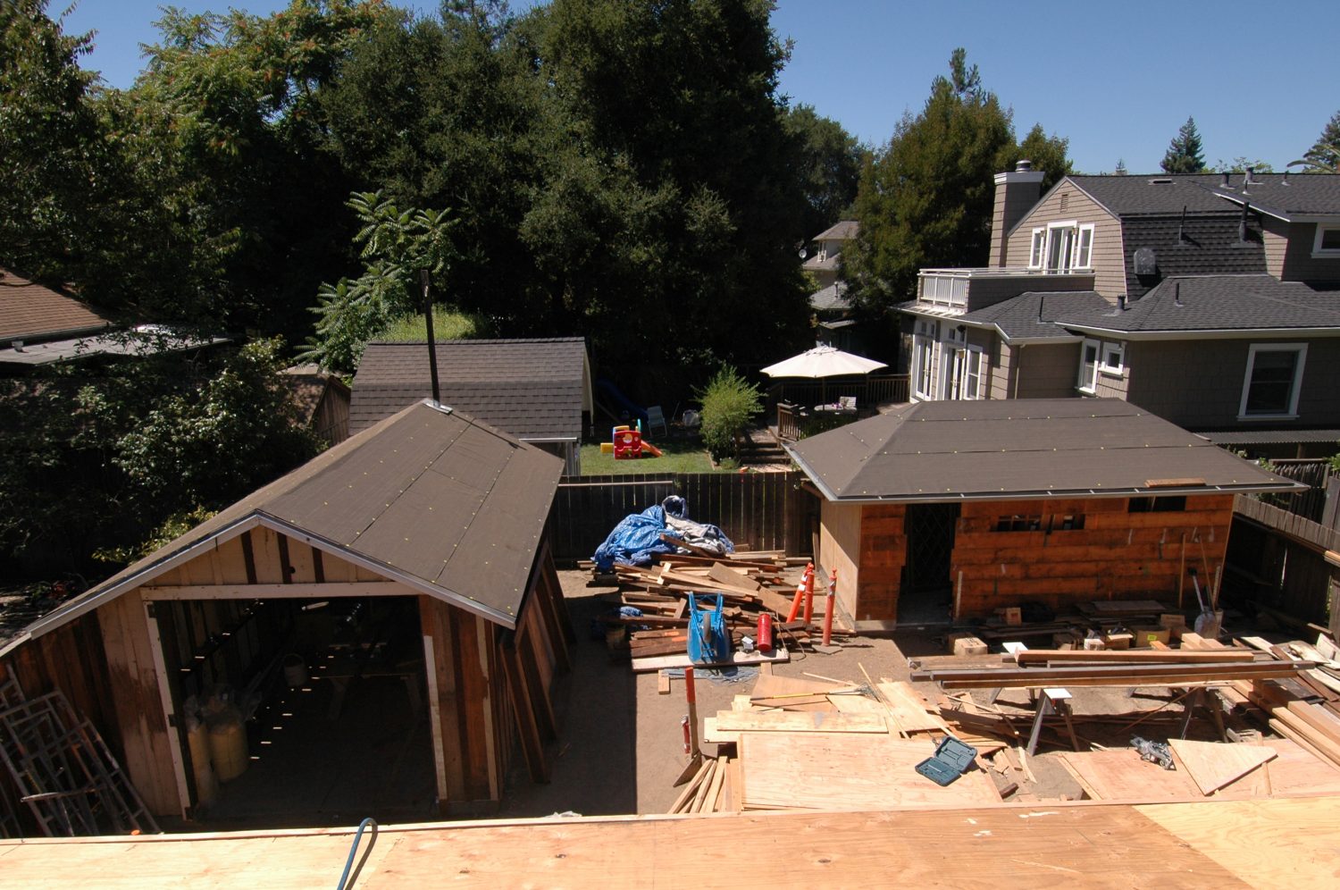 A photo of the restoration efforts at Addison Avenue focusing on the new roofs of the shed and garage.