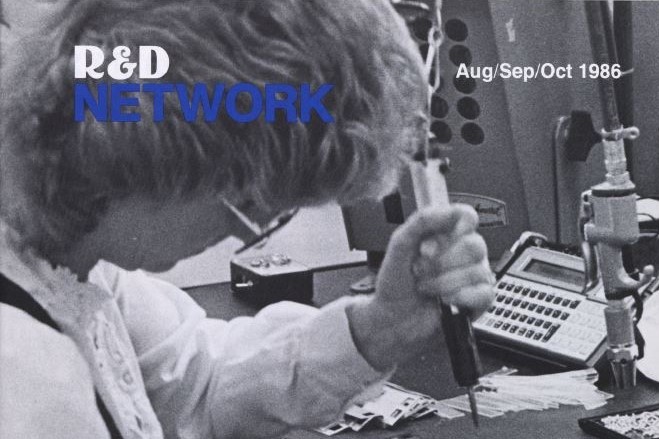 Cover of R&D Network from the fall of 1986 featuring Collen Kimble working on the final assembly of a series 10C calculator.