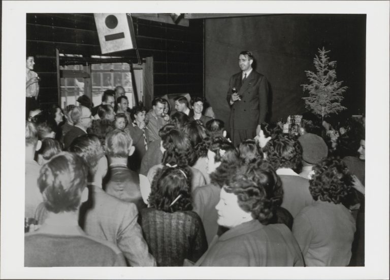 Dave Packard addresses a large crowd at a Hewlett-Packard Christmas party in 1945.