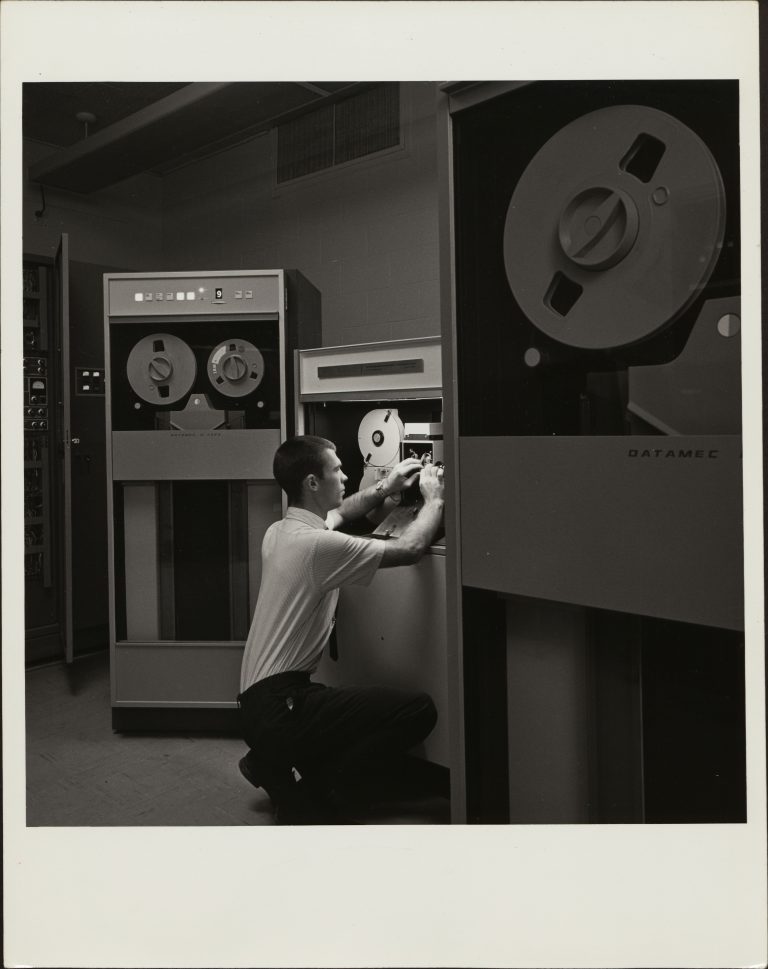 Man works on the SC4400 magnetic tape recorder.