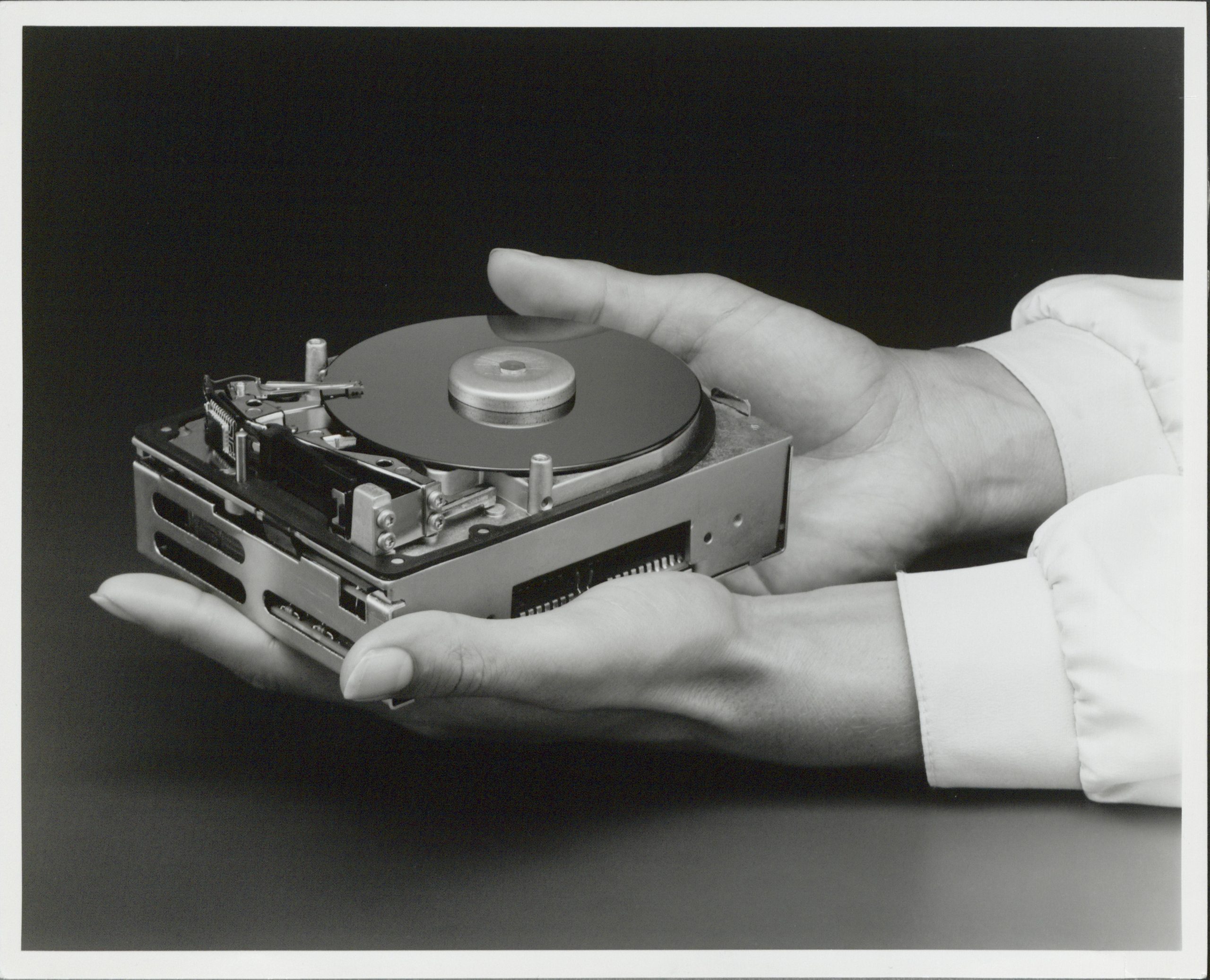 The HP 7963 storage drive held in someone's hands outside of its case.