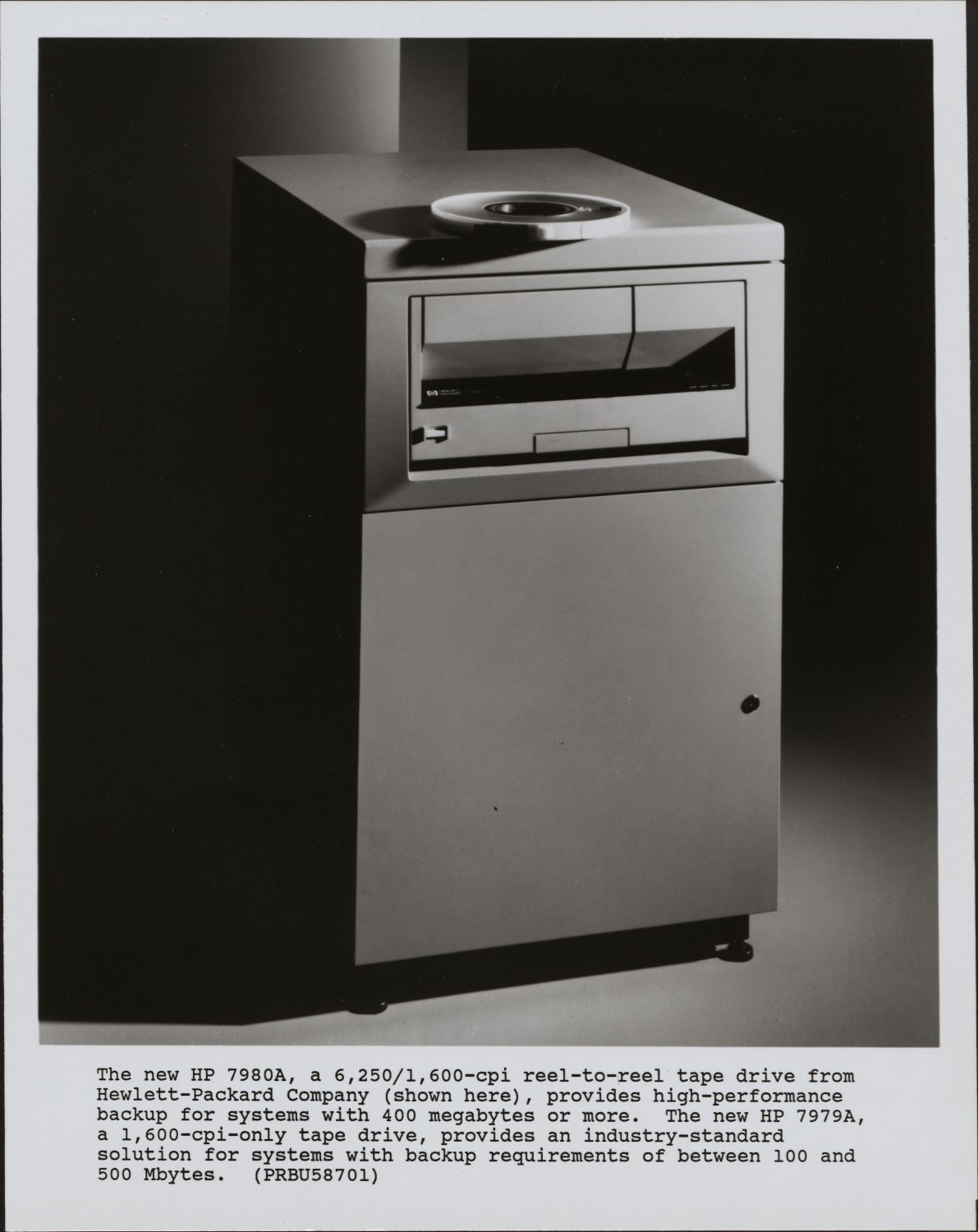 Photo of the HP 7980A data backup system with a typed product description underneath from 1988.