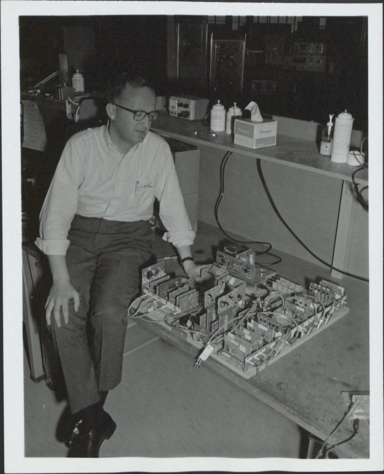 Fred Johnstone next to a breadboard emulator in 1967.