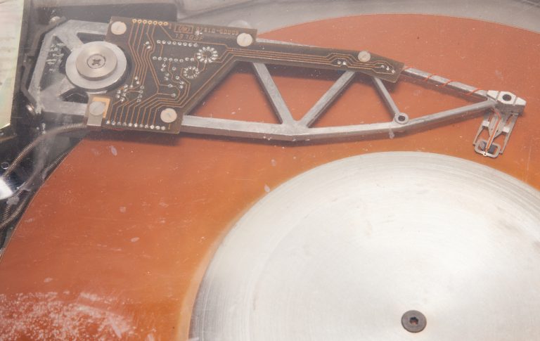 Close-up view of the platter and arm of the HP 7910 disk drive.
