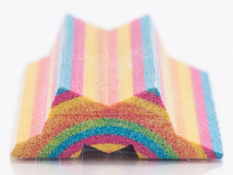 Close-up view of the end of the 3D-printed rainbow-like structure showcasing the texture and colors.
