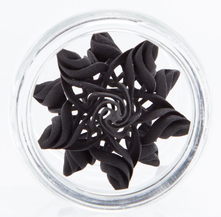 3D-printed geometric design in a glass container (bottom up view).