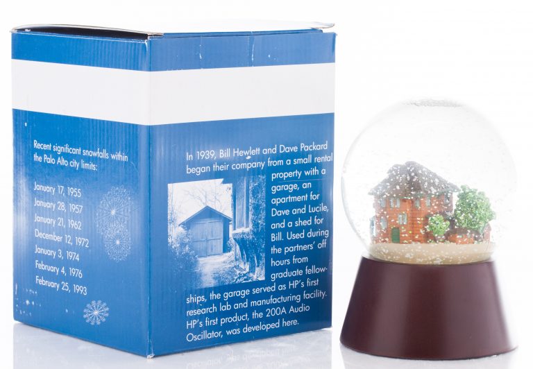 The Garage Snow Globe with back of the box highlighting the story of the property.