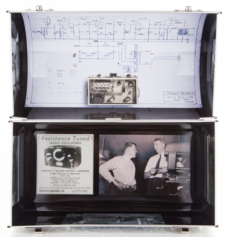 Photo of the top and bottom of the lunchbox interior (bottom features an ad for the oscillator and a photo of Bill and Dave).