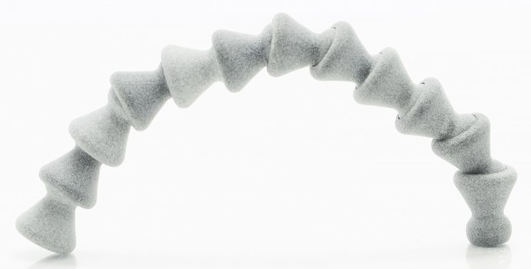 A 3D-printed demo object with ball and socket joints formed continuously into an arch.