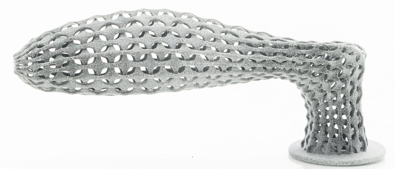 A 3D-printed door handle with hollow interior and weave pattern exterior. 