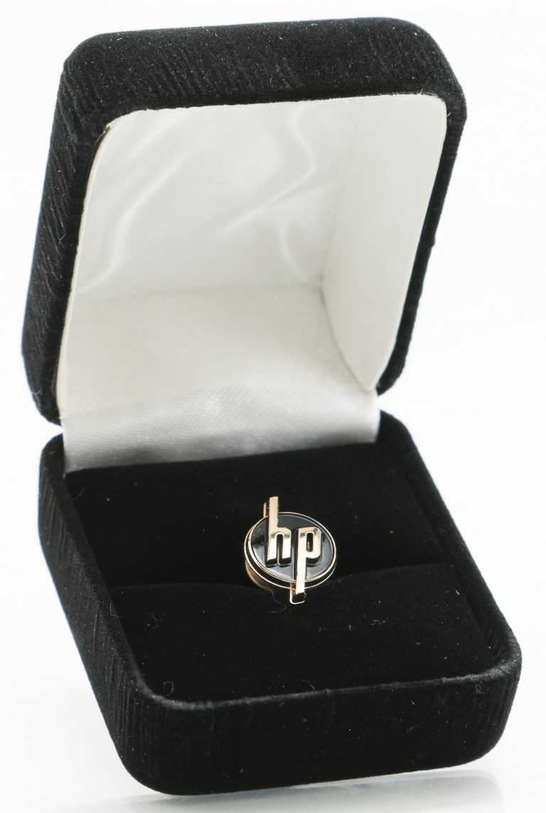 Pin with the HP logo in its box created for the 20th anniversary of the logo in 1966.