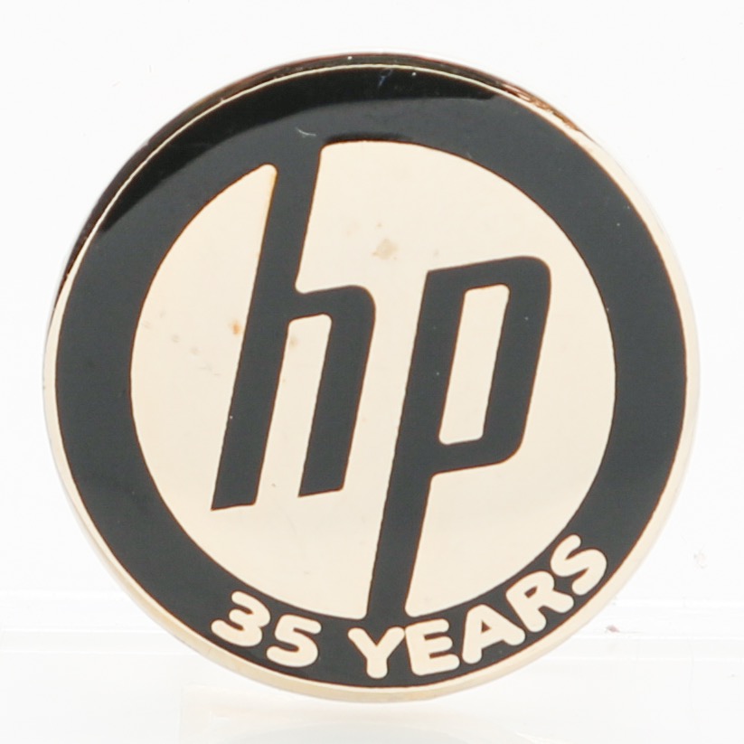 Hewlett-Packard pin given for 35 years of service to the company. The black and gold pin reads 