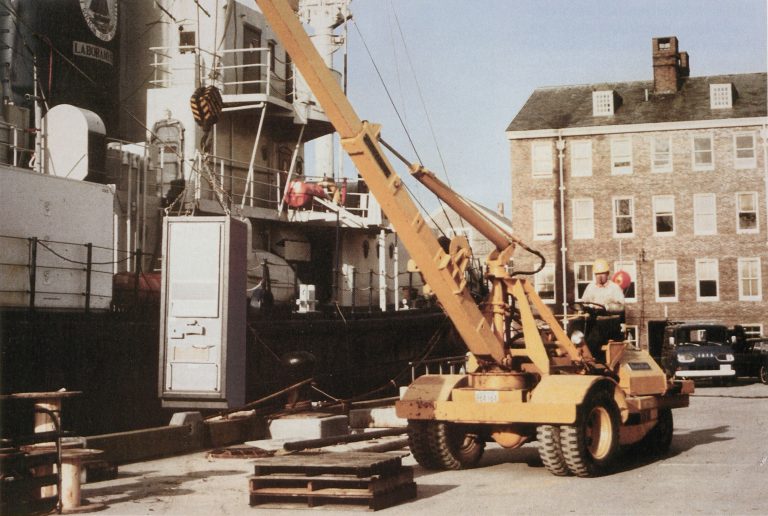A crane lifts a Hewlett-Packard computer onto the research vessel Chain in 1966.