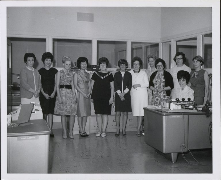 A group of 12 female employees of Hewlett-Packard pose for a photo in an office in the 1960s.