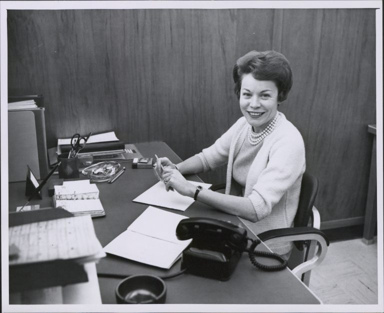 A photo of Anne Laudel at her desk in the 1960s.