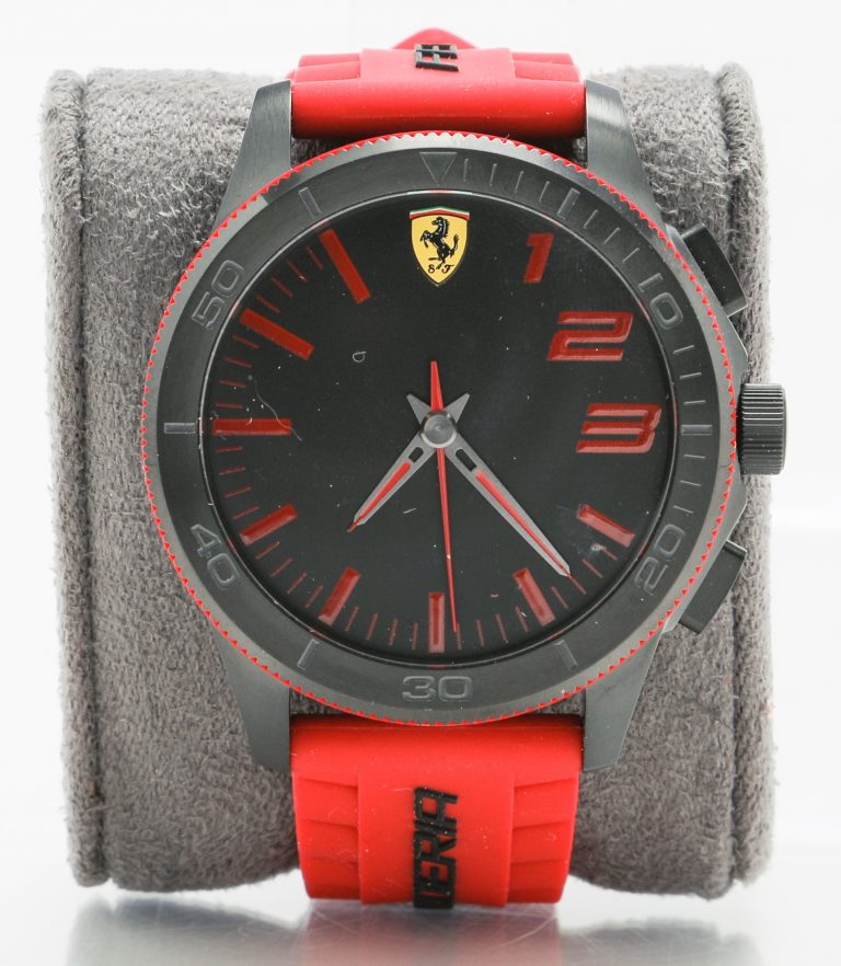 Photo of the Ferrari smartwatch powered by HP. It features a red watchband, red accents and a dark dial face.