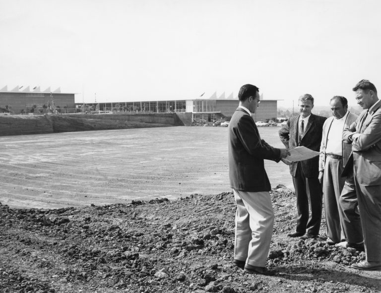 A team of architects and engineers studying blueprints on the grounds of the HP campus at Stanford Industrial Park.