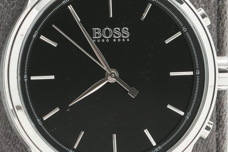 Smartwatch produced by Hugo Boss with HP technology. It features black band and watch face with silver accents and frame.