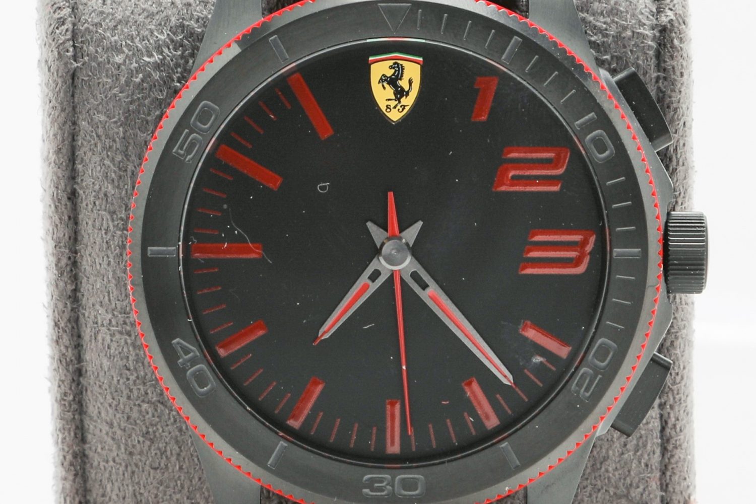 Photo of the Ferrari smartwatch powered by HP. It features a red watchband, red accents and a dark dial face.