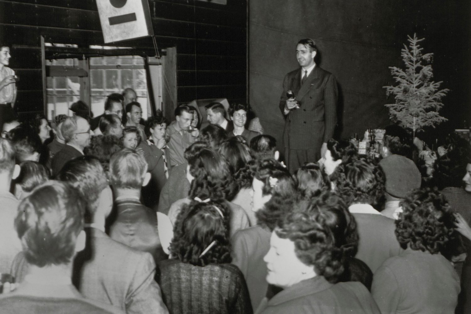 Dave Packard addresses a large crowd at a Hewlett-Packard Christmas party in 1945.